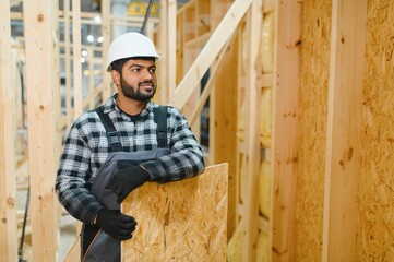 Construction of modular houses. Indian construction worker or engineer at construction site