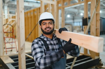 Indian carpenter works on the construction of modular houses