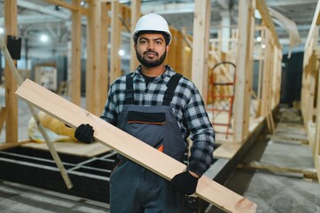 Indian carpenter works on the construction of modular houses