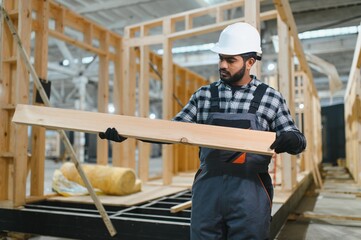 Indian carpenter works on the construction of modular houses
