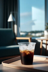 Iced coffee in plastic cup on wooden tray in sunlit modern living room interior