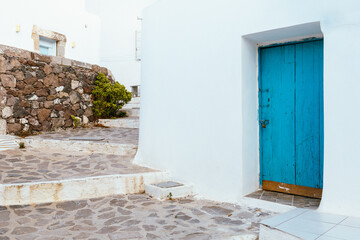 Traditional blue wooden door in Plaka village, Milos island, Greece