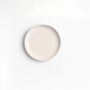 Minimal round ceramic plate mockup top view, isolated on white background, blank and empty for food presentation, restaurant branding, or product design showcase

