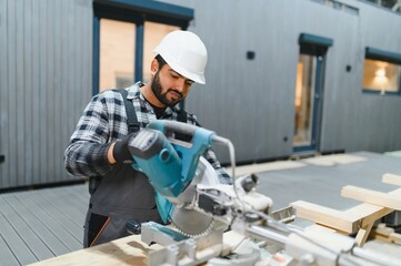 Indian carpenter works on the construction of modular houses