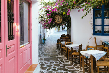 Charming alley with flowers and tables, Plaka, Milos, Greece
