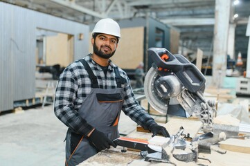 Indian carpenter works on the construction of modular houses