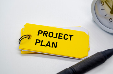 Project Plan on yellow notepad with black marker