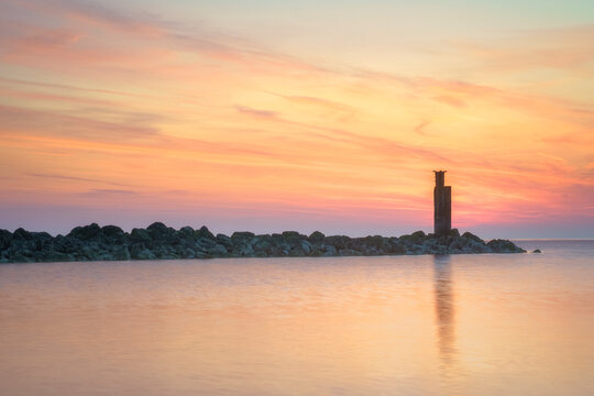 breakwater-sunset-beacon-tranquil-sea.tif