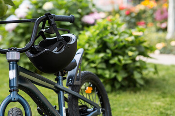 Fototapeta premium Bike and safety helmet outdoors. Active sport. Protection. Life insurance and children's safety.