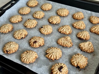 oatmeal cookies on parchment paper on a baking sheet