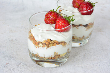 Yogurt Parfaits with Strawberries, muesli and fresh berries in drinking glasses