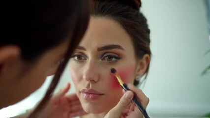Makeup Artist Applying Blush to a Young Woman's Face