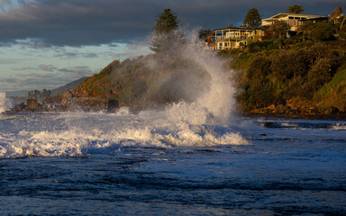 Wave splashing into the rocky shore.