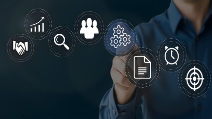 Businessman interacting with virtual icons for team management, workflow optimization, goal...
