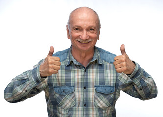 Cheerful senior man showing thumbs up expression with a friendly smile against a plain background