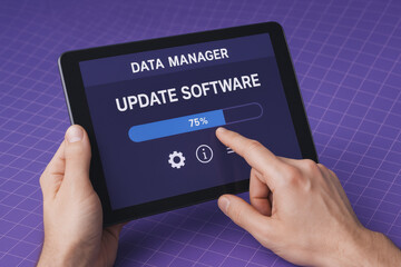 A close-up hands interacting with a tablet displaying software update progress emphasizes data management and digital efficiency in business operations