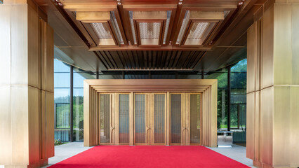 Elegant interior space with large doors and red carpet