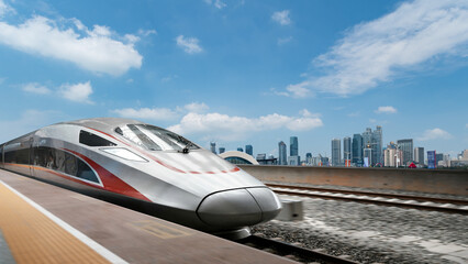 Obraz premium Modern high - speed train running through urban area