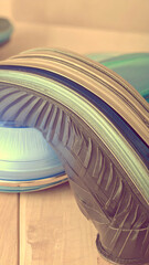 A close-up of colorful, curved plastic materials stacked together.