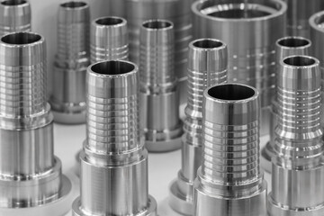 Collection of metal pipes with a silver finish. The pipes are of various sizes and shapes. Concept of industrial design and precision