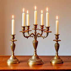 Vintage brass candlesticks with lit candles on wooden table  