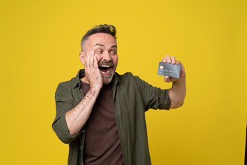 cash proposal for people. excited mature man with a hand gesture at his cheek in casual green shirt...