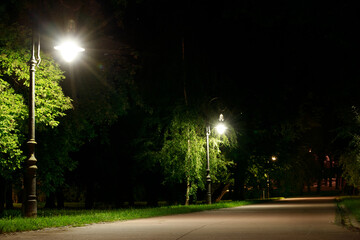long exposure photography night park outdoor scene without people here on walking road along lantern illuminated lamp