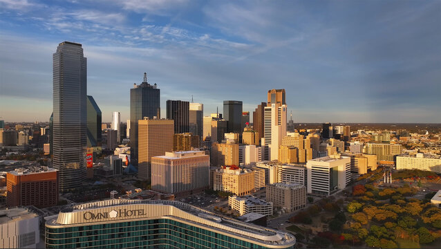 Dallas, United States - 25 June 2025: Aerial view of the city's skyline, where the iconic Bank of America Plaza pierces the sky, casting long shadows over the Omni Hotel.