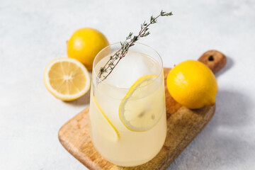 Bee's Knees Cocktail against a light background. Refreshing Lemon Thyme cocktail based on gin,...