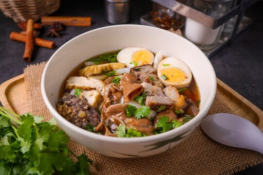 Chinese rolled noodles with crispy pork and egg in black soup,Rolled Rice Noodles in Five-spices Broth , Chinese noodles, thai called kuay jap