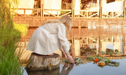 On Ivan Kupala, a girl makes a wish and throws a wreath into the river.