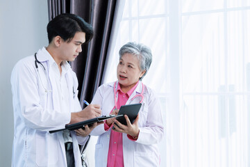 professor coat doctor give advice and discuss with intern student for surgery planning and patient treatment in the hospital medical school. healthcare and medical education concept.