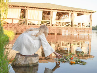 On Ivan Kupala, a girl makes a wish and throws a wreath into the river.