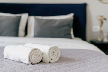 Elegant hotel bedroom with neatly arranged bedding and towels for a welcoming stay