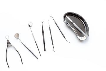 Dental equipment tools for teeth care on white background. Professional Dentist desktop, top view