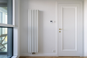 Modern electric heater and programmable thermostat in a stylish living space