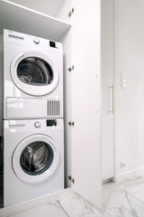 Modern washing machine and dryer pair in a stylish laundry space