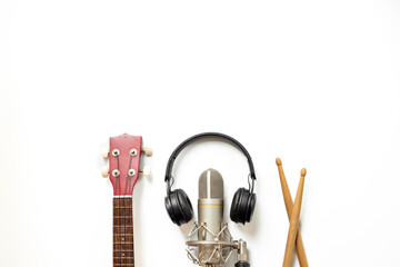 Musical instruments for band - small guitar, drumsticks and tambourine with studio microphone....