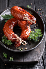 Tasty cured sausage smoked with juniper and wood.