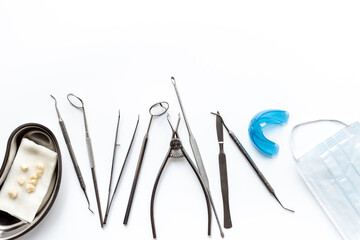 Dental equipment tools for teeth care on white background. Professional Dentist desktop, top view