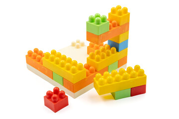 Colorful plastic building blocks assembled into a structure on white background