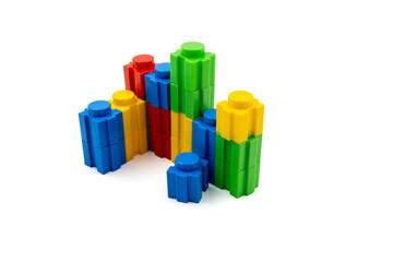 Colorful stacked plastic building blocks on white background