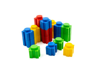 Colorful stacked plastic building blocks on white background
