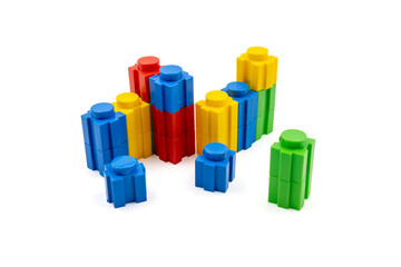 Colorful stacked plastic building blocks on white background