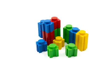 Colorful stacked plastic building blocks on white background