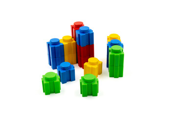 Colorful stacked plastic building blocks on white background