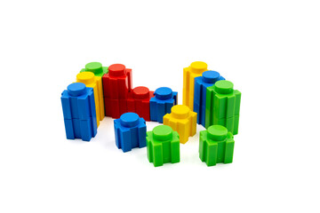 Colorful stacked plastic building blocks on white background