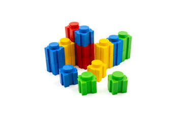 Colorful stacked plastic building blocks on white background