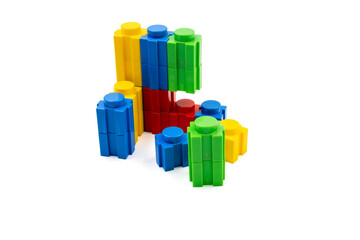 Colorful stacked plastic building blocks on white background