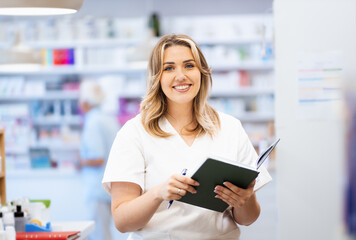 Portrait of female pharmacist in drugstore.